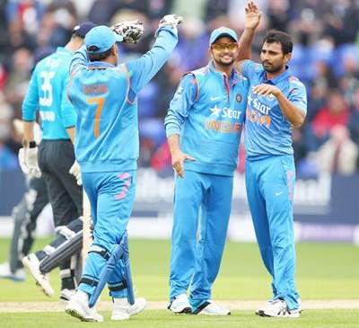 Left to right: Mahendra Singh Dhoni, Suresh Raina and Mohammed Shami celebrate the fall of an English wicket in the second ODI in Cardiff on Wednesday., 