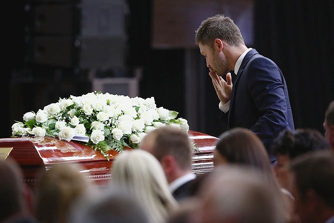 Australian cricket captain Michael Clarke pays his respect to Phillip Hughes during the funeral service on Wednesday