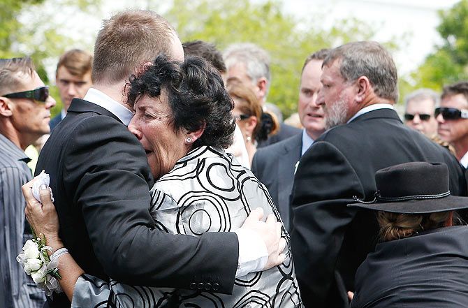 Phillip Hughes's mother, Virginia, embraces her son Jason during the funeral on Wednesday