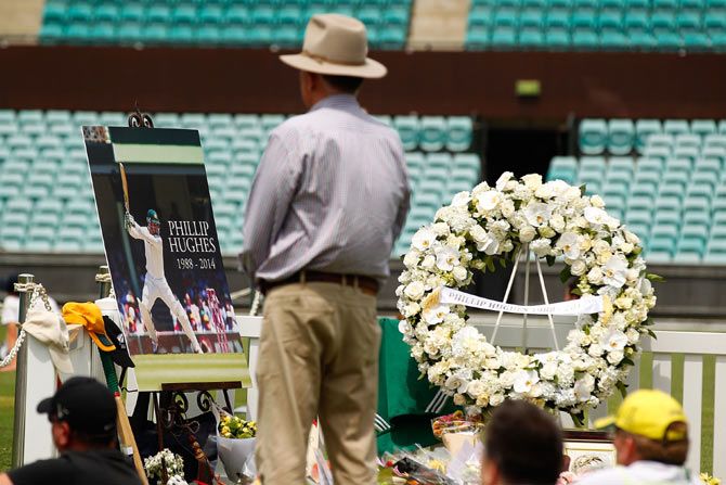 People gather to watch the funeral service for Phillip Hughes at the Sydney Cricket Ground