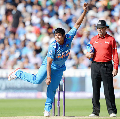Karn Sharma of India bowls