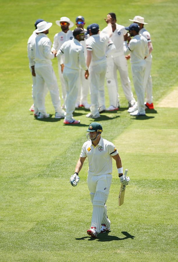 Shane Watson of Australia walks from the ground after he was dismissed by India's Varun Aaron