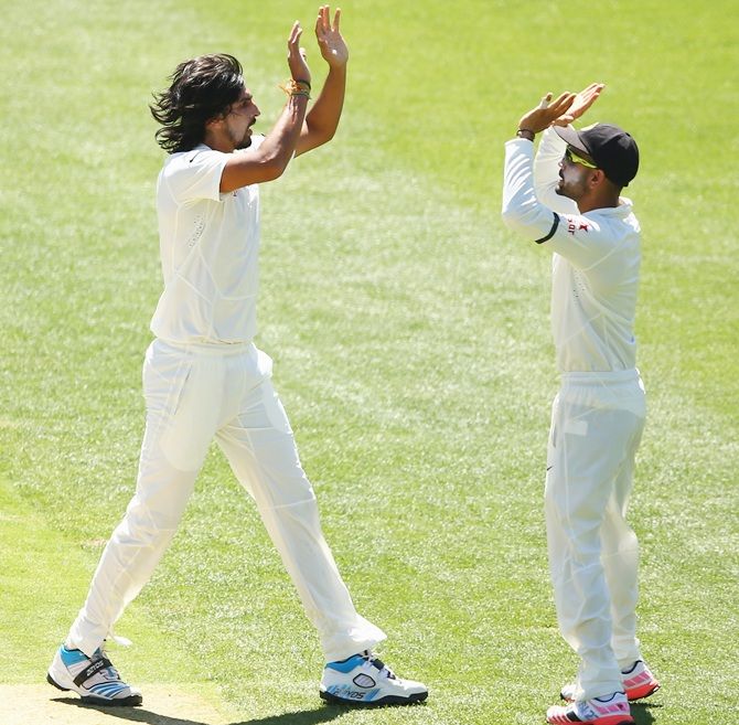 Ishant Sharma of India celebrates Virat Kohli after taking the wicket of Chris Rogers