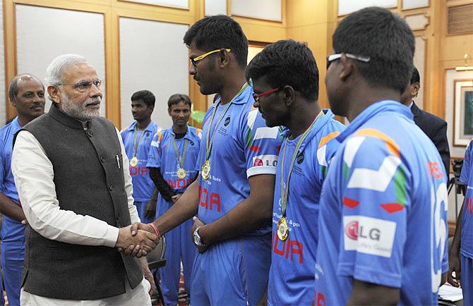 Prime Minister, Narendra Modi greets members of the Indian Blind World Cup-winning team in New Delhi on Wednesday