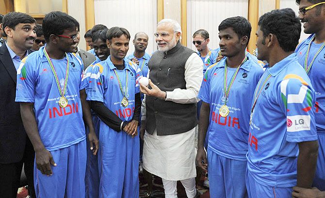 Prime Minister Narendra Modi talks to the members of the Indian Blind World Cup-winning team in New Delhi on Wednesday