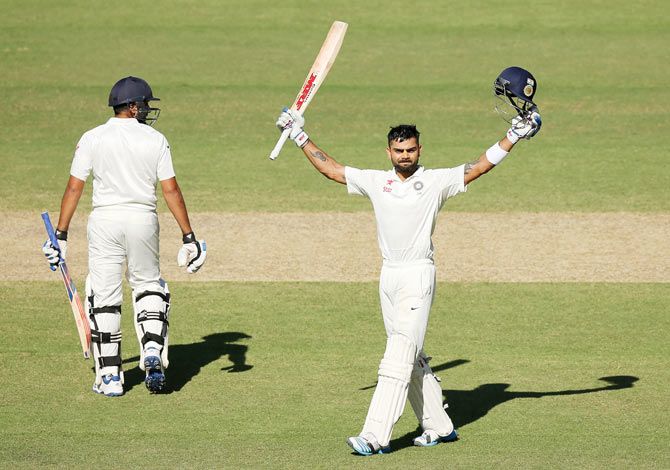 India captain Virat Kohli celebrates after completing his century on Day 3 of the first Test against Australia at the Adelaide Oval on Thursday