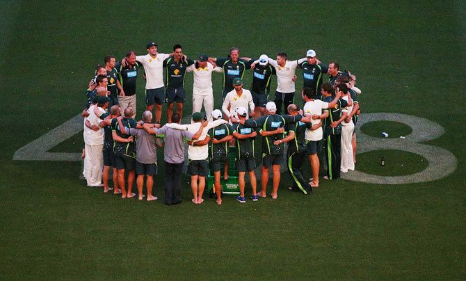 Nathan Lyon stands in the middle of the Australian team huddled over the number 408 which was dedicated to the late Phillip Hughes after their win on Saturday