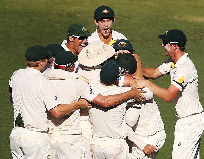 Australian players celebrate winning the first Test after Ishant Sharma was dismissed by Nathan Lyon