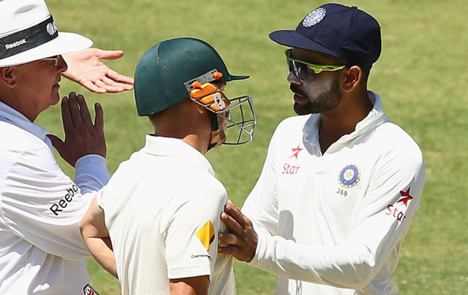 India captain Virat Kohli speaks to David Warner