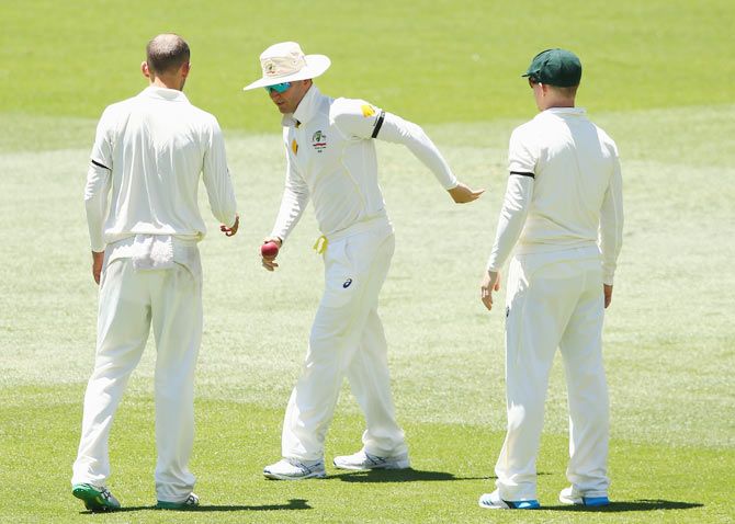 Michael Clarke of Australia tries to find his feet after pulling his hamstring while fielding on Saturday