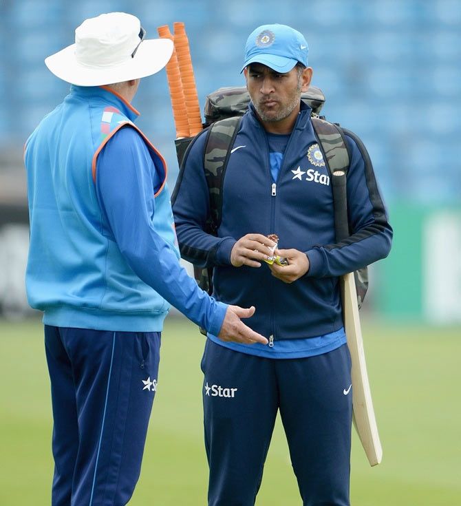 Mahendra Singh Dhoni of India speaks with coach Duncan Fletcher during a nets session