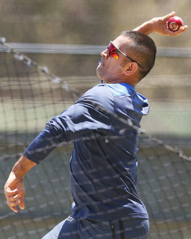 MS Dhoni bowls in the nets during an India training session