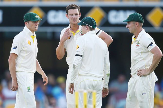 Josh Hazlewood of Australia talks to captain Steve Smith about an injury on Day 1 of the 2nd Test on Wednesday
