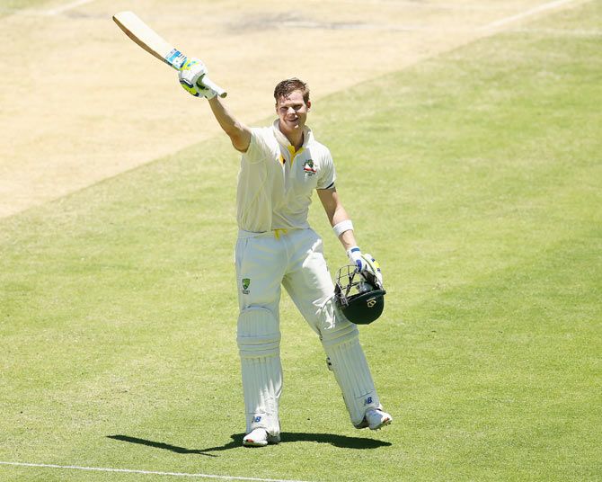 Australian captain Steve Smith celebrates scoring a century on Day 3 of the second Test against  India at The Gabba in Brisbane on Friday