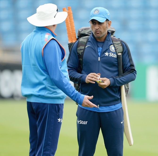 Mahendra Singh Dhoni of India speaks with coach Duncan Fletcher during a nets session 