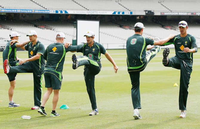Australian players warm up during a team training session