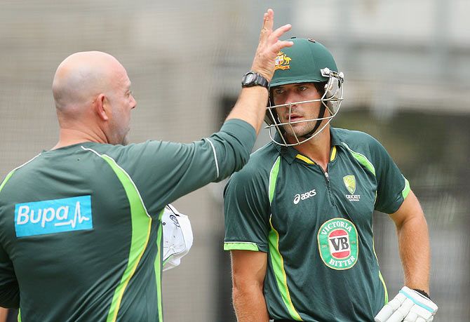 Darren Lehmann the coach of Australia talks to Joe Burns during a team training session at Melbourne Cricket Ground on Tuesday