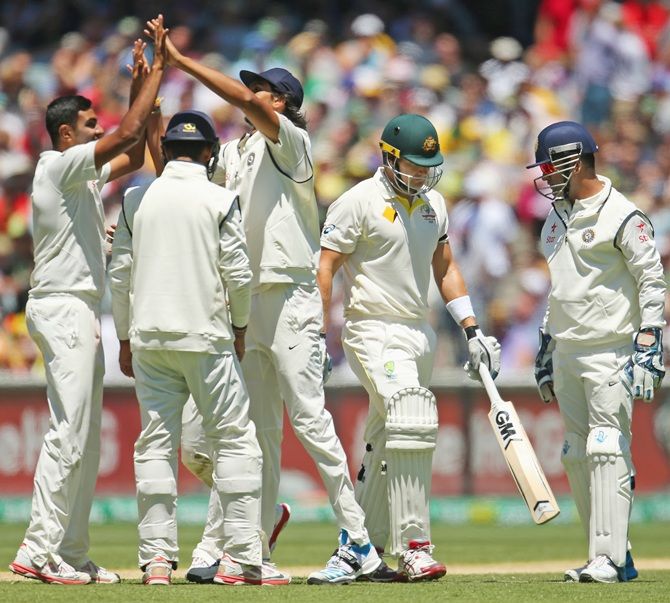 Ravichandran Ashwin of India celebrates with his teammates after dismissing Shane Watson of Australia
