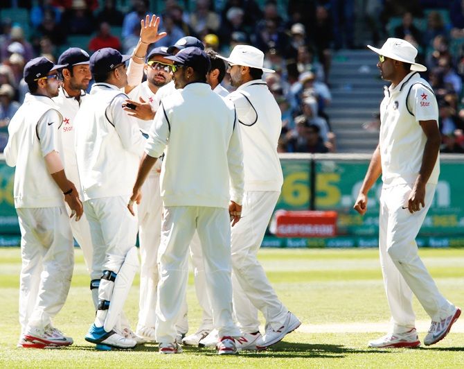 Indian players celebrate the wicket of Shaun Marsh of Australia