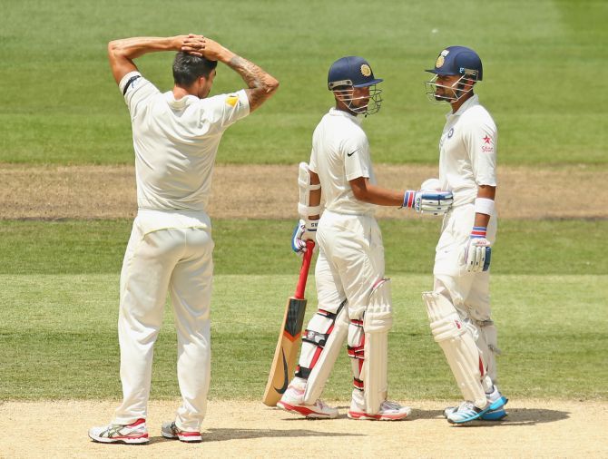 Virat Kohli of India and bowler Mitchell Johnson of Australia exchange words