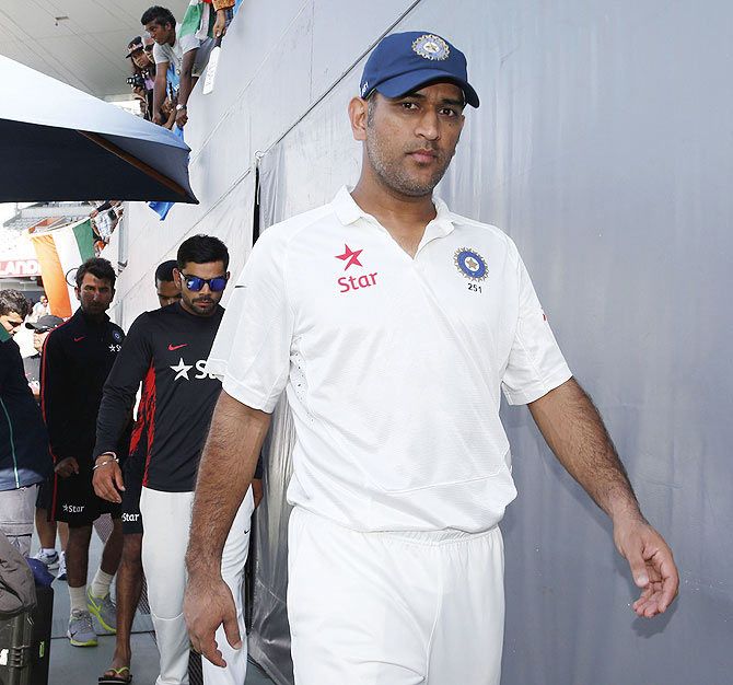 India captain Mahendra Singh Dhoni leads his team back to the dressing room