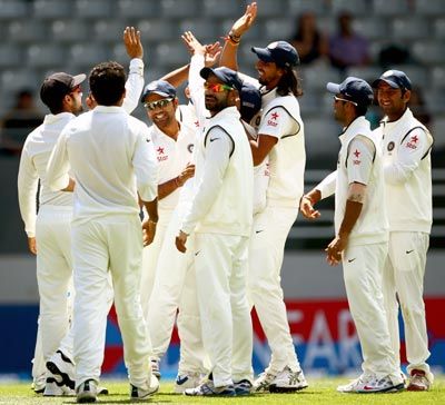The Indian players celebrate the run out of Brendon McCullum