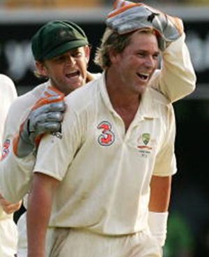 Adam Gilchrist and Shane Warne celebrate a dismissal during the first Ashes Test between Australia and England at The Gabba on November 26, 2006
