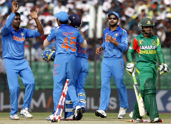 Bangladesh's Mominul Haque (right) leaves the field as India's fielders celebrate his dismissal