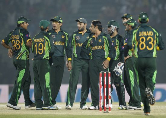 Pakistan players celebrate the fall of a wicket