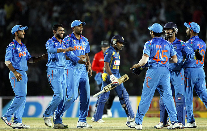 Sri Lanka's Mahela Jayawardene leaves the field as India's fielders celebrate his dismissal
