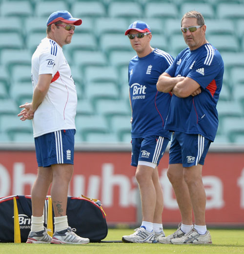 England coach Andy Flower speaks with bowling coach David Saker and batting coach Graham Gooch during a nets session