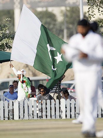 A fan waves a Pakistan flag during the final day of England's second practice match against the Pakistan Cricket Board XI at the ICC Global cricket academy ground in Dubai in January 2012