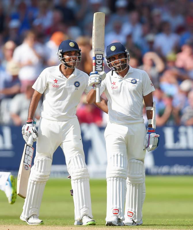 India batsmen Mohammed Shami (right) and partner Bhuvneshwar Kumar celebrate their 100-run partnership for the last wicket.