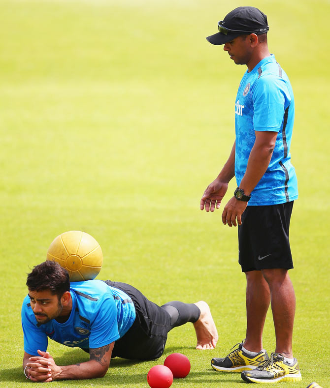 India's Virat Kohli (left) looks on during a India nets session