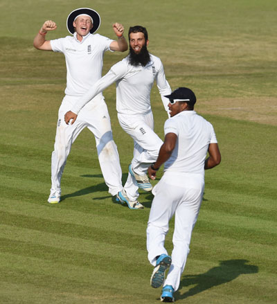 England bowler Moeen Ali celebrates after taking the wicket of India batsman Virat Kohli