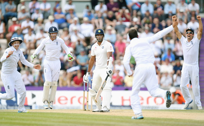 England bowler Moeen Ali and captain Alastair Cook (right) celebrate after taking the wicket of India batsman Pankaj Singh to win the match