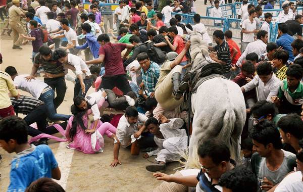 A police man falls from his horse while evicting the crowd in front of the Eden Gardens, ahead of the felicitation function for IPL champions Kolkata Knight Riders, in Kolkata on Tuesday.
