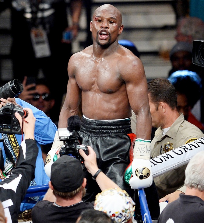 Floyd Mayweather celebrates after defeating Marcos Maidana by majority decision in their WBC/WBA welterweight unification fight at the MGM Grand Garden Arena on May 3, 2014 in Las Vegas