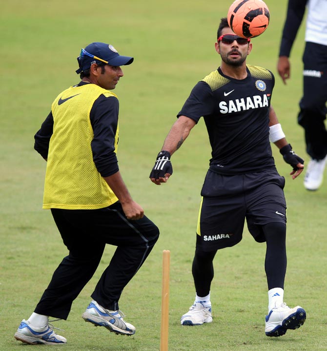 Virat Kohli (right) and Mohammed Shami play football during a practice session
