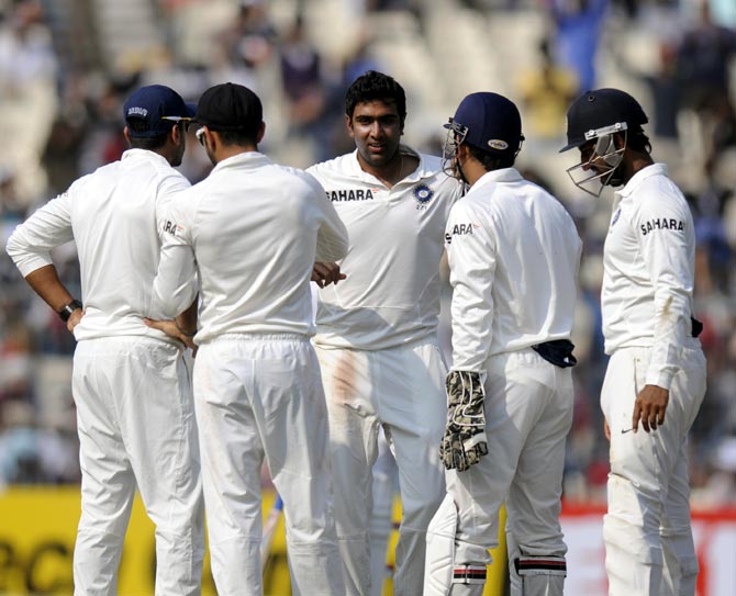 R Ashwin (centre) celebrates a wicket with his team mates
