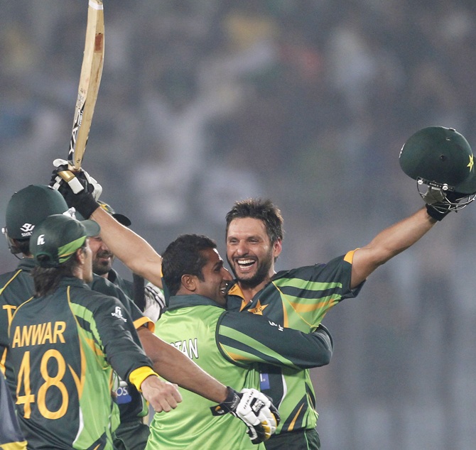 Pakistan's Shahid Afridi,right, celebrates with teammates after Pakistan won the match against India.