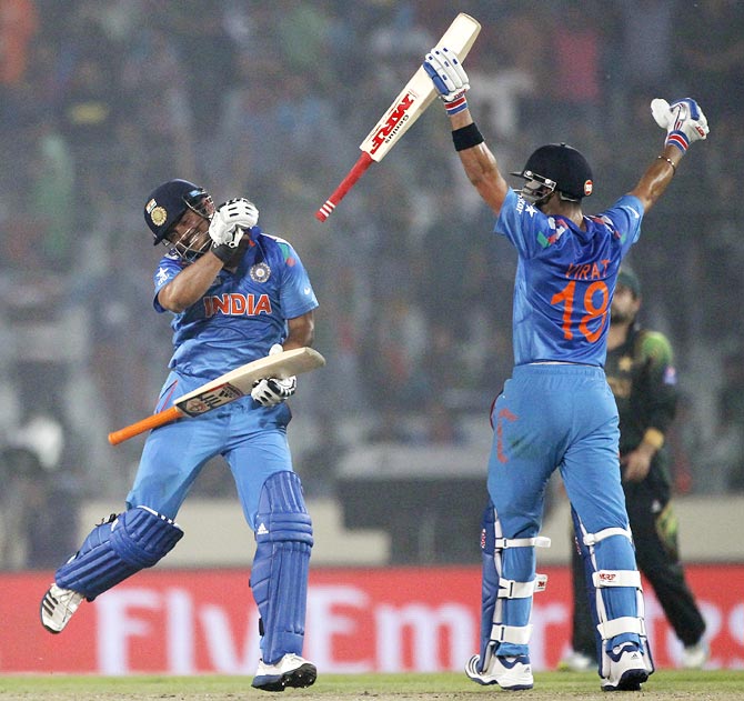 Virat Kohli, right, and Suresh Raina celebrate India's victory against Pakistan