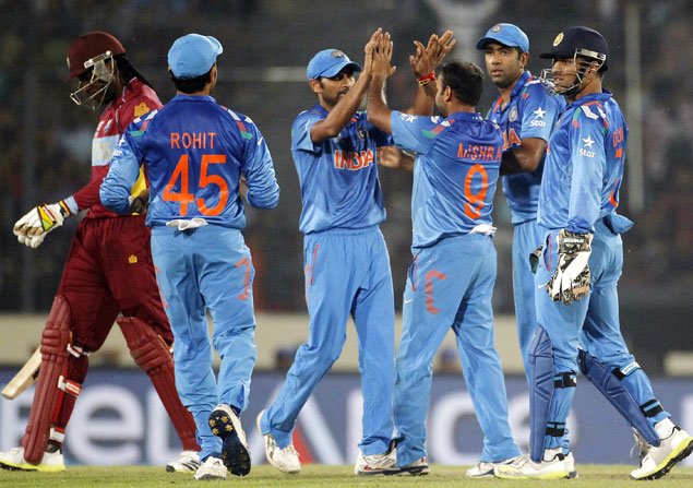West Indies' Chris Gayle, left, leaves the field as India's fielders celebrate his dismissal during their ICC Twenty20 World Cup match at the Sher-E-Bangla National Stadium