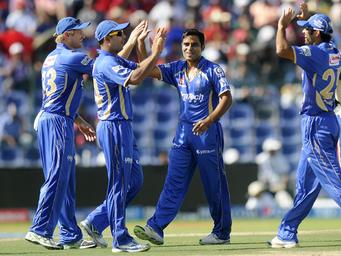 Rajat Bhatia is congratulated by Rajasthan teammates after taking a wicket