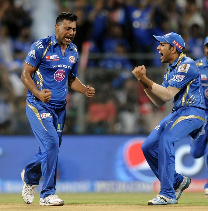 Praveen Kumar (left) and Rohit Sharma celebrate the wicket of Brendon McCullum.