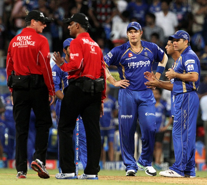 Rajasthan Royals players and the umpires discuss the run-rate calculations.