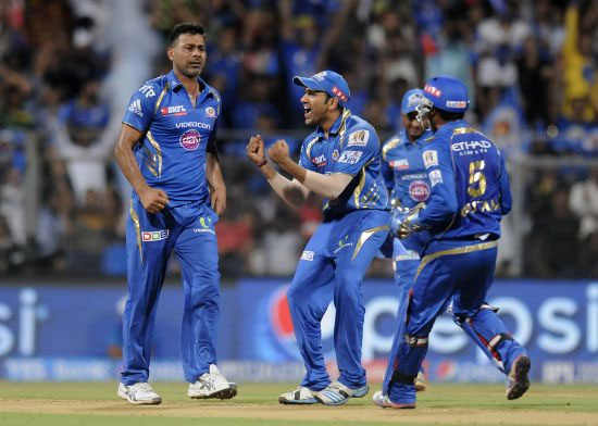 Mumbai Indians players celebrate after picking a wicket.