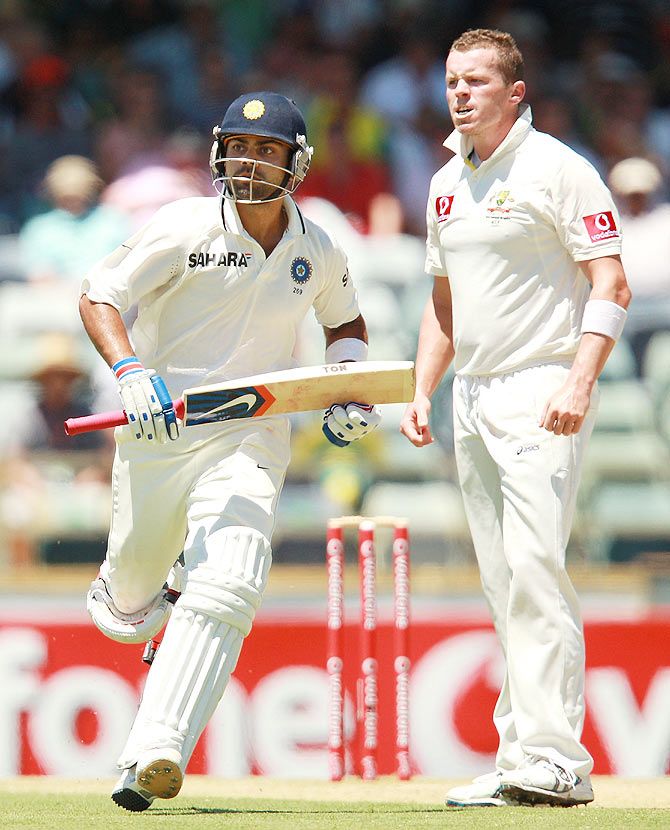  Virat Kohli of India runs past Peter Siddle of Australia during day three of the Third Test match between Australia and India