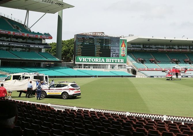 A helicopter lands on the field of play after Phillip Hughes of South Australia was struck   in the head by a delivery