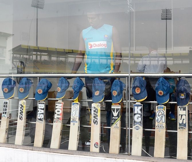 Sri Lanka captain Angelo Mathews look on as his team put their bats out in memory of   Australian cricketer Phil Hughes
